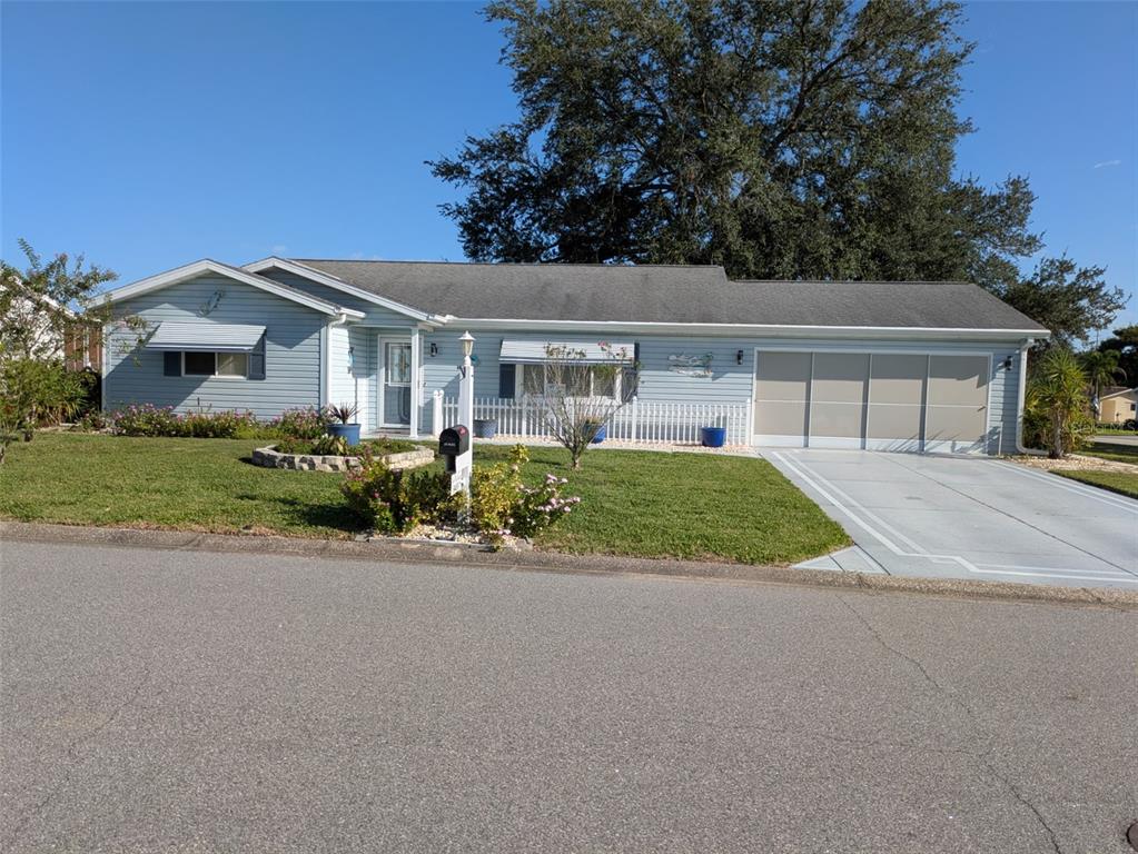 9499 Southeast 174th Loop Summerfield, FL 34491 - Photo 3 of 46 front view of house with a yard