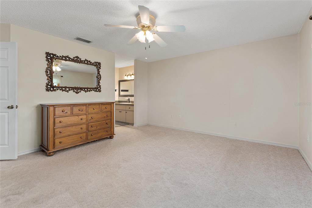 9499 Southeast 174th Loop Summerfield, FL 34491 - Photo 33 of 46 an empty room with a cabinet and mirrors