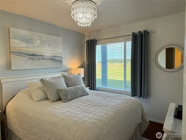 a bedroom with a bed and a chandelier