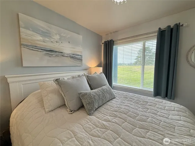 a bed sitting in a bedroom next to a window