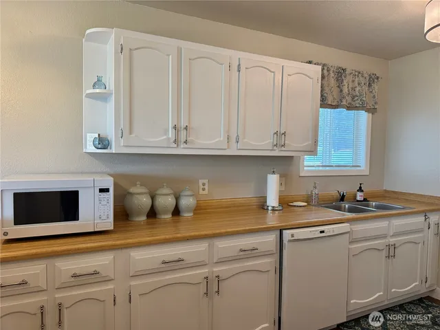 a kitchen with white cabinets and a sink