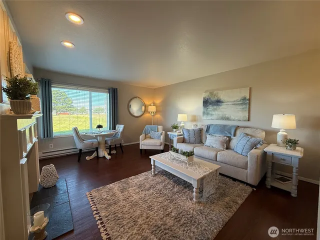 a living room with furniture and a large window