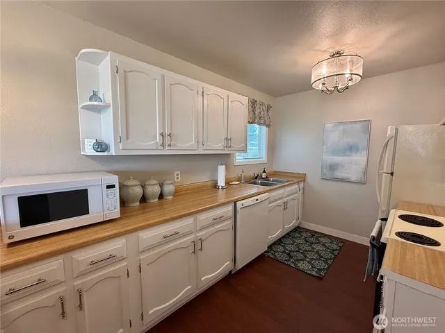 a kitchen with stainless steel appliances granite countertop a sink stove and cabinets