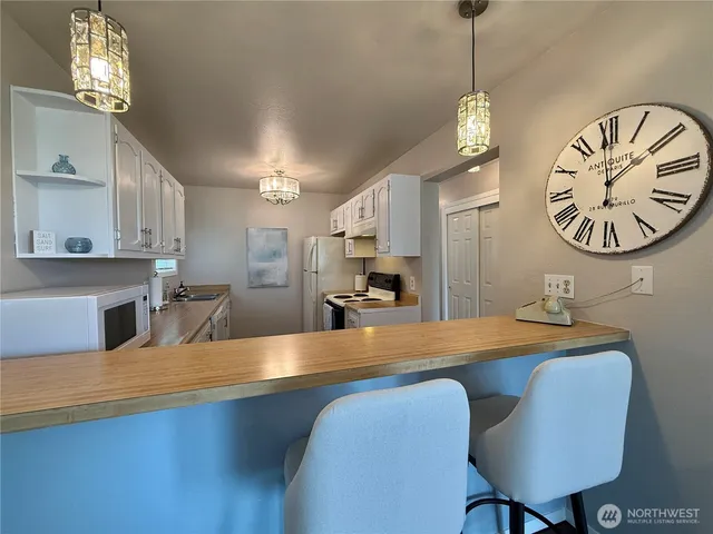 a view of a dining room with furniture and a chandelier