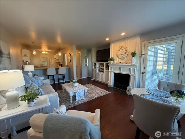 a living room with furniture a fireplace and a table