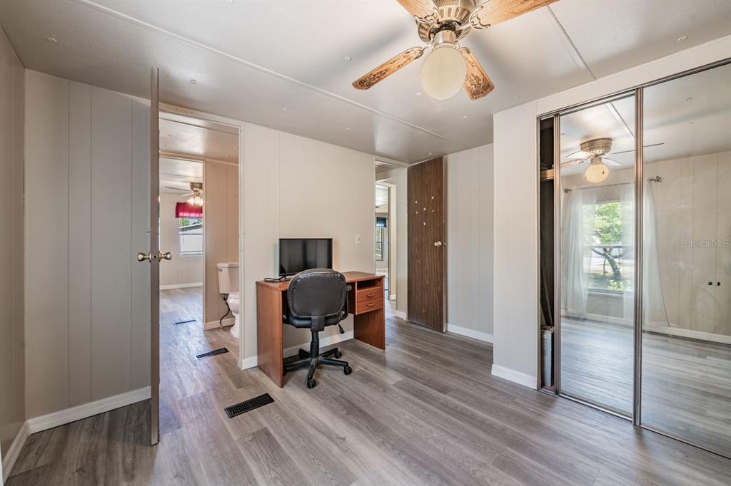 9739 Ray Street Hudson, FL 34669 - Photo 29 of 36 a view of a workspace with furniture and wooden floor