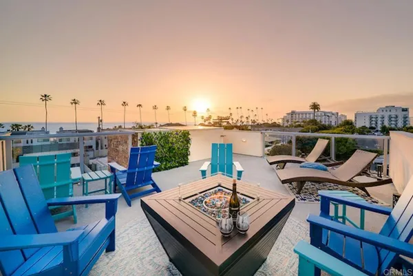 a view of a hallway with wooden floor and a bathroom