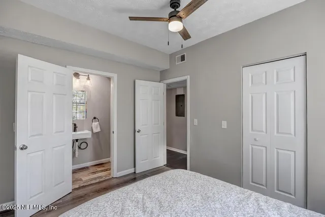 a view of a big room with closet and a chandelier fan
