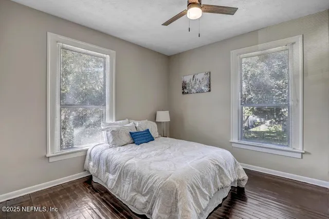 a bedroom with a large bed and a window