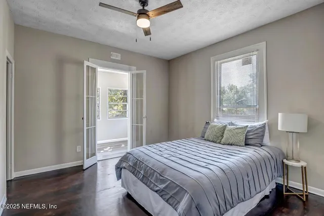 a bedroom with a large bed and a window