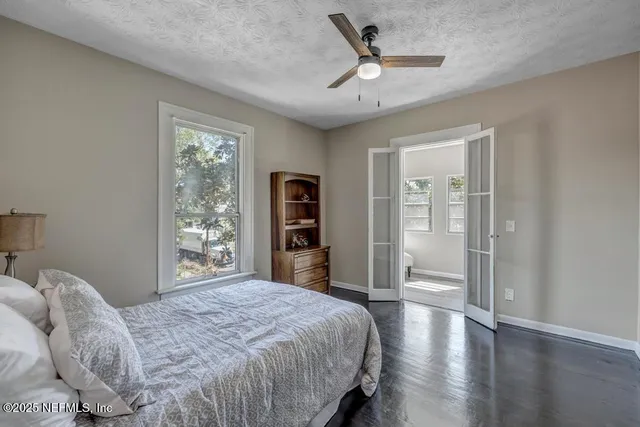 a bedroom with a large bed and a window