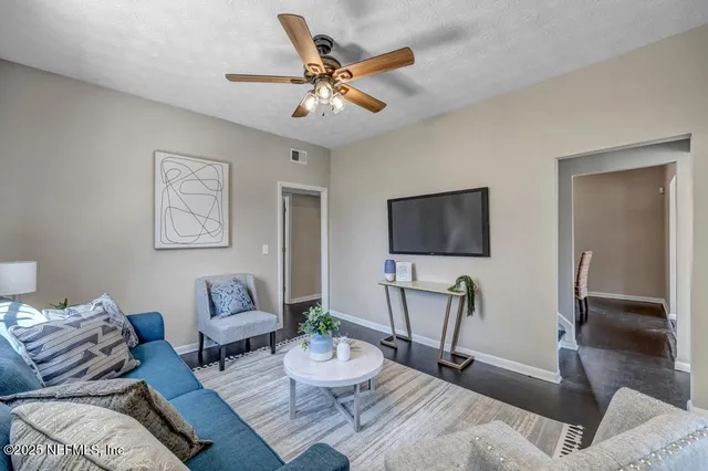 a living room with furniture and a flat screen tv