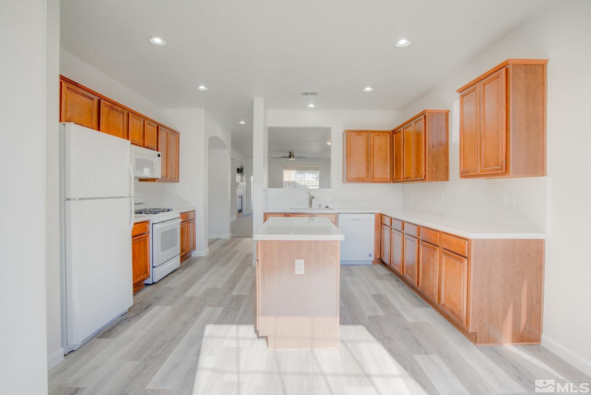 10510 Iron Point Circle Reno, NV 89521 - Photo 13 of 32 a large kitchen with stainless steel appliances granite countertop a large counter top a sink a stove and a refrigerator