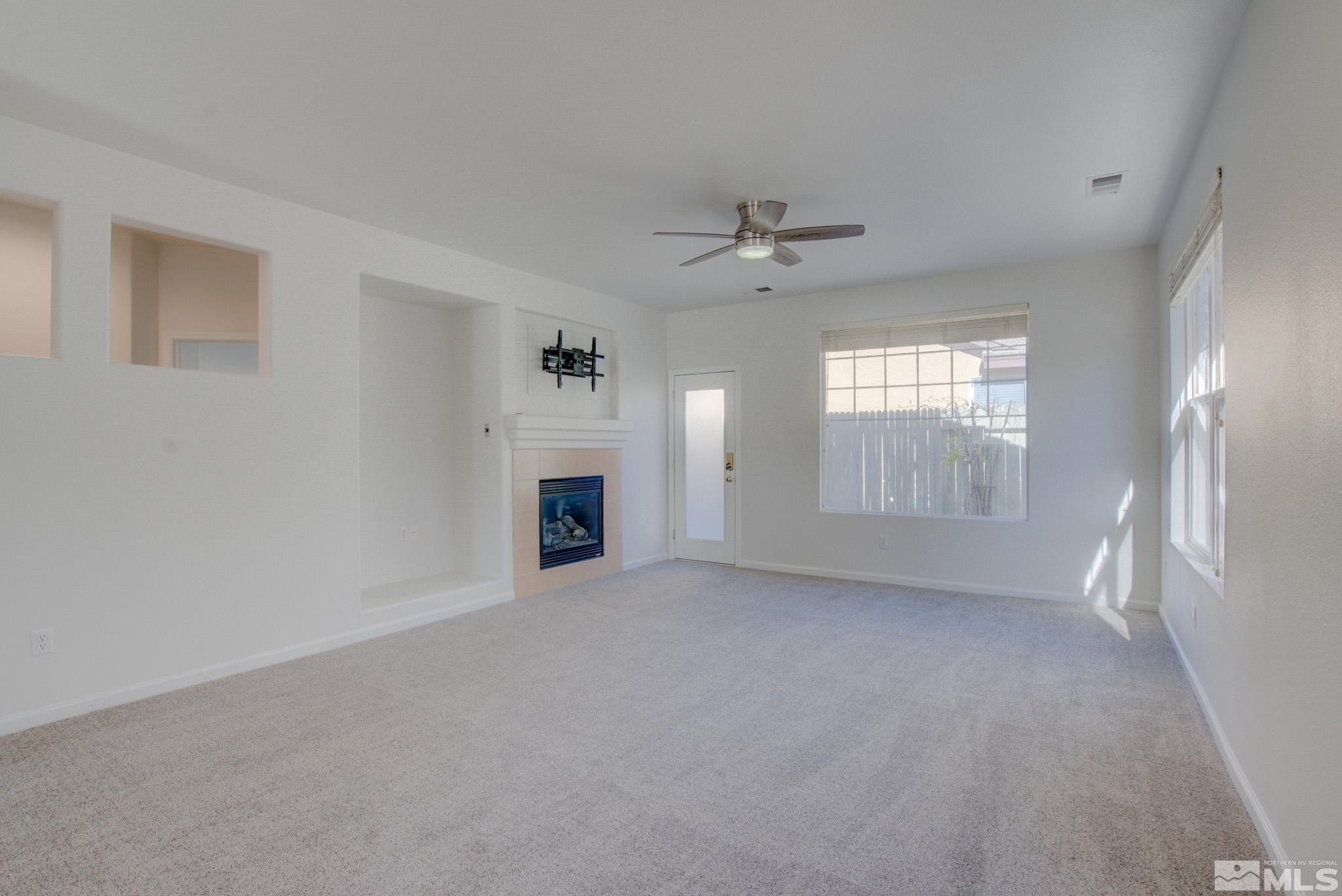 10510 Iron Point Circle Reno, NV 89521 - Photo 8 of 32 an empty room with windows and fireplace
