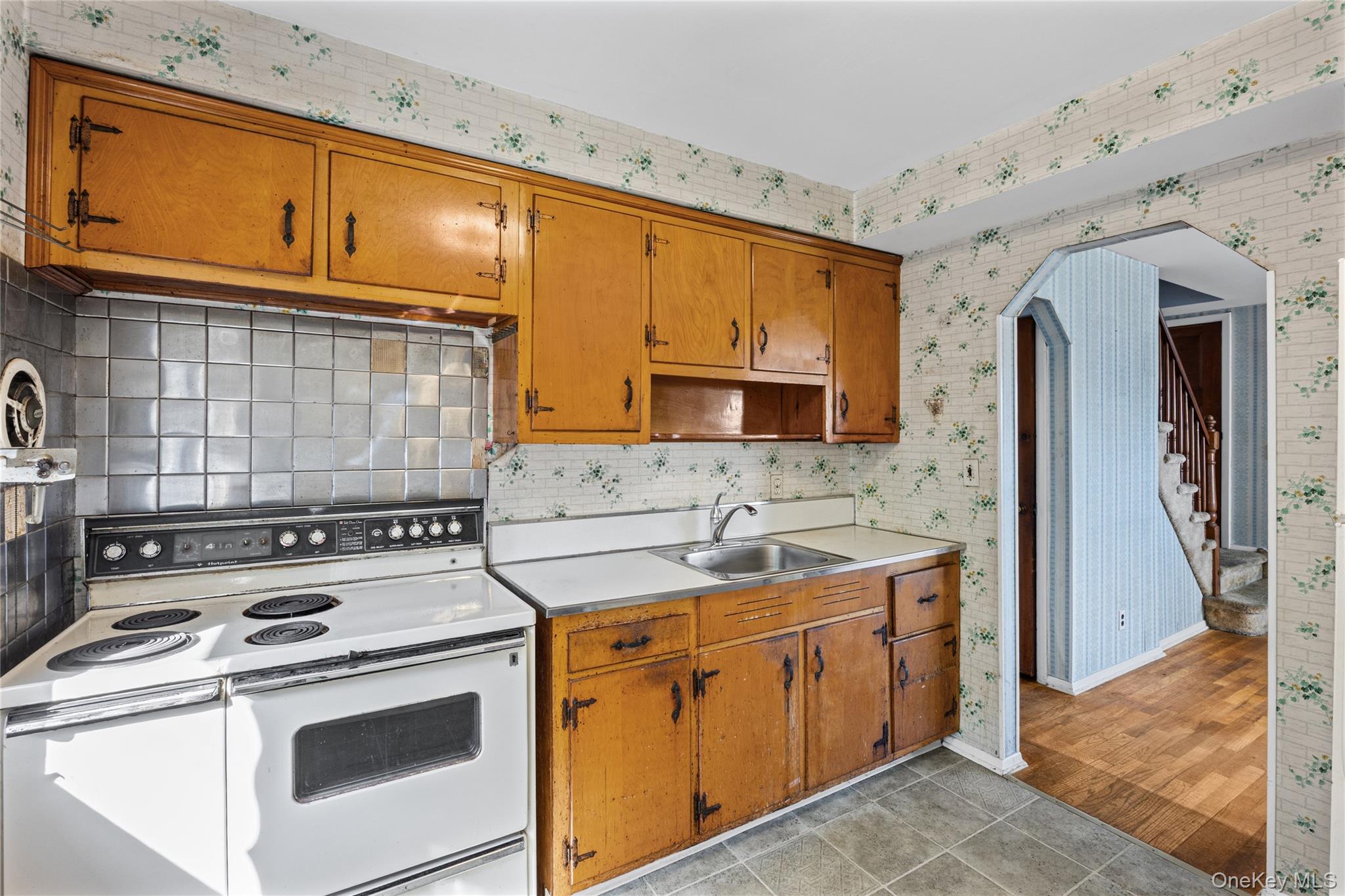 21 Morris Road Bethpage, NY 11714 - Photo 10 of 39 a kitchen with a stove sink and cabinets
