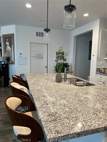 a bedroom with a bed and chandelier