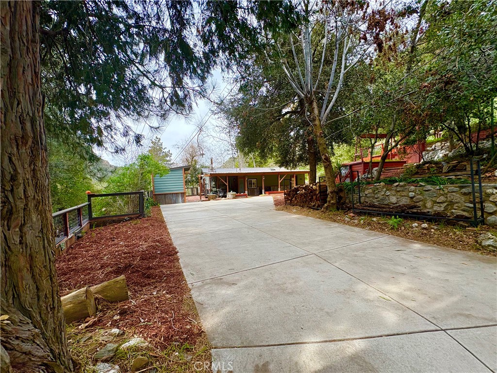 36750 Hilltop Road Yucaipa, CA 92399 - Photo 3 of 27 a view of house with backyard and trees