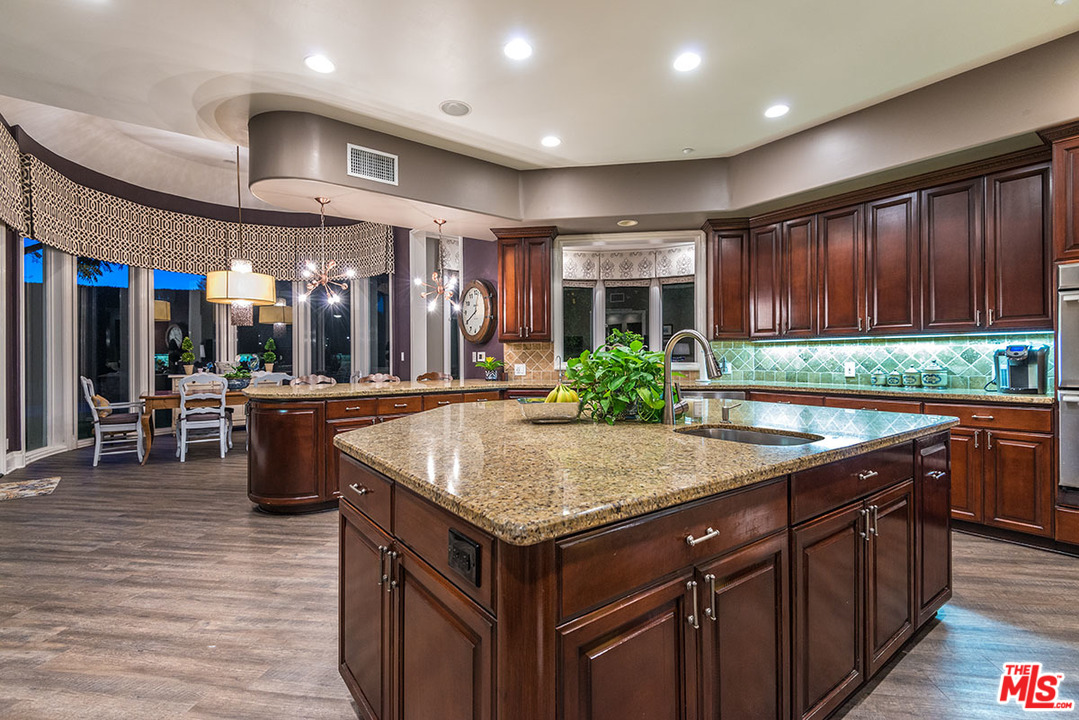 13981 Aubrey Road Beverly Hills, CA 90210 - Photo 8 of 20 a kitchen with center island table and chairs