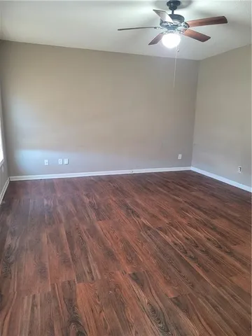 a view of an empty room and wooden floor