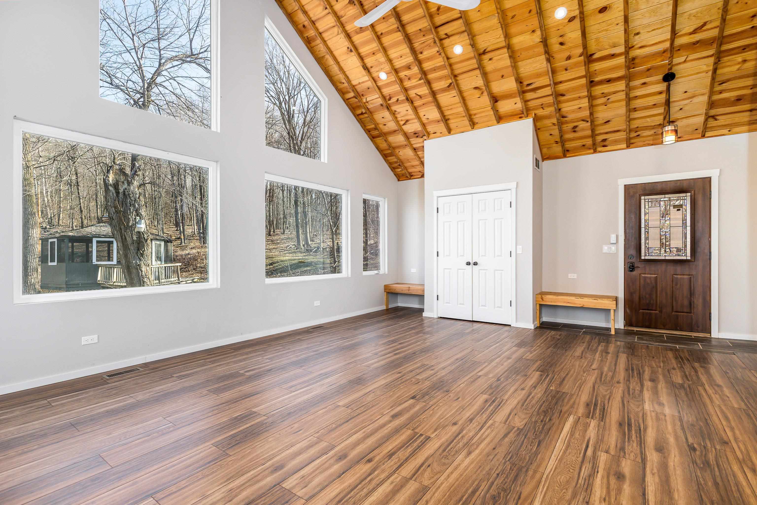 4785 South River Road Hanover, IL 61041 - Photo 6 of 46 a view of an empty room with wooden floor and a window