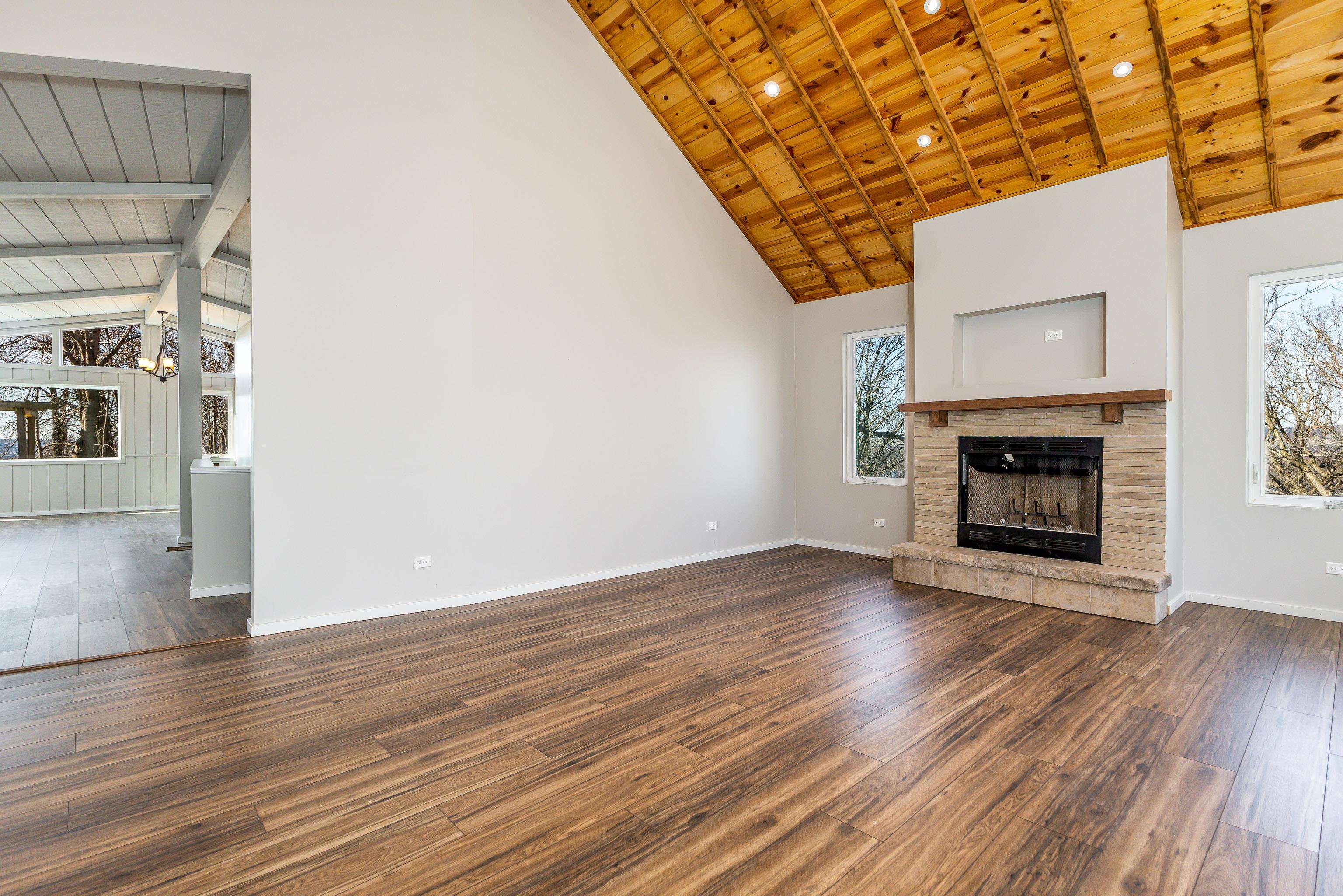 4785 South River Road Hanover, IL 61041 - Photo 7 of 46 a view of an empty room with wooden floor and a fireplace