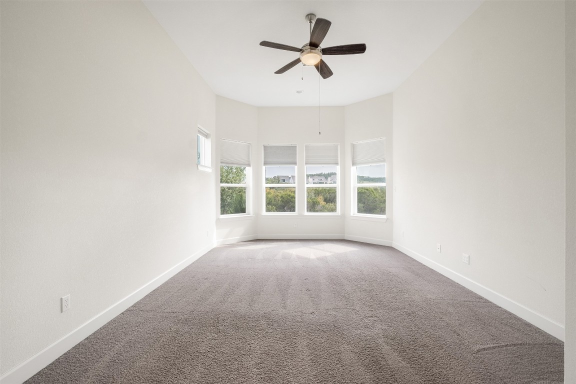 748 Hazy Hills Loop Dripping Springs, TX 78620 - Photo 25 of 40 Spare room with carpet flooring and a ceiling fan