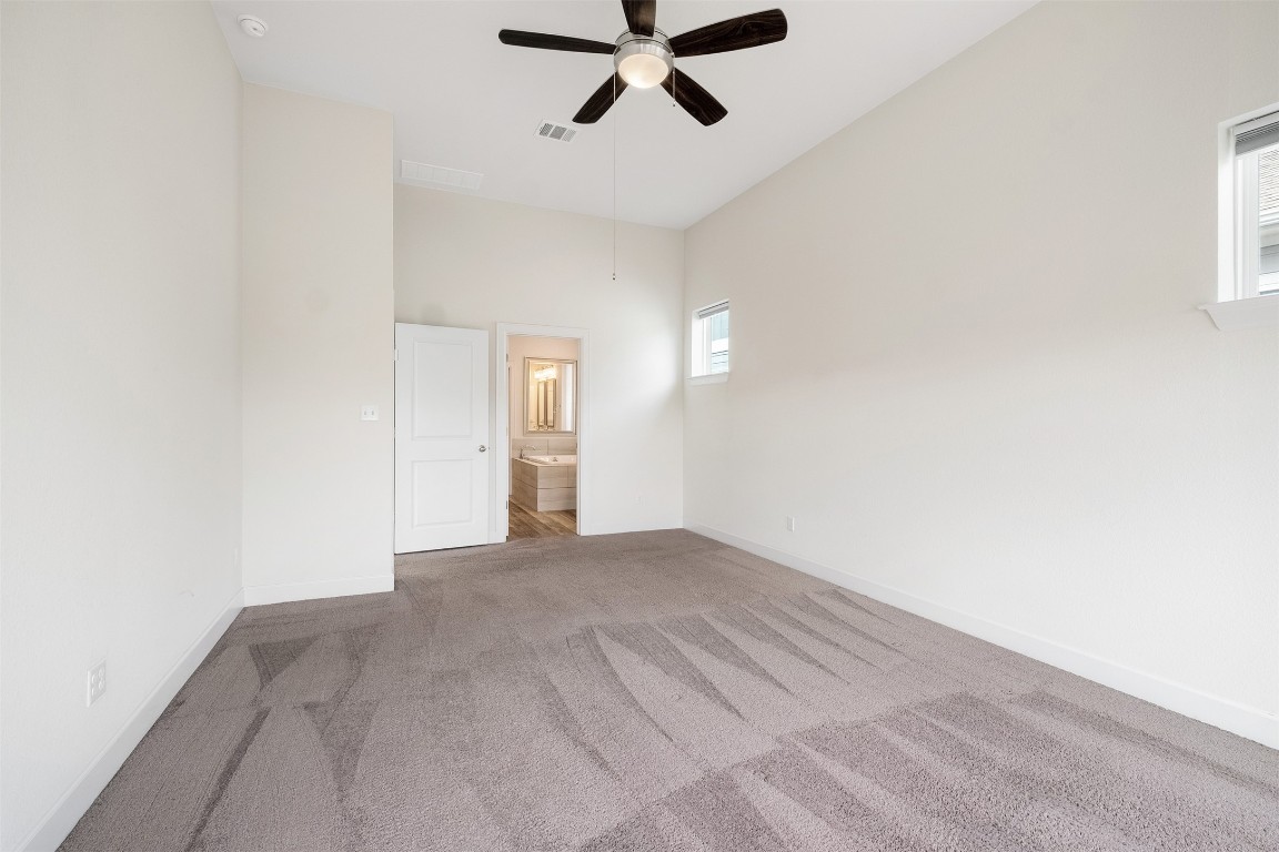 748 Hazy Hills Loop Dripping Springs, TX 78620 - Photo 26 of 40 Carpeted empty room featuring ceiling fan and baseboards