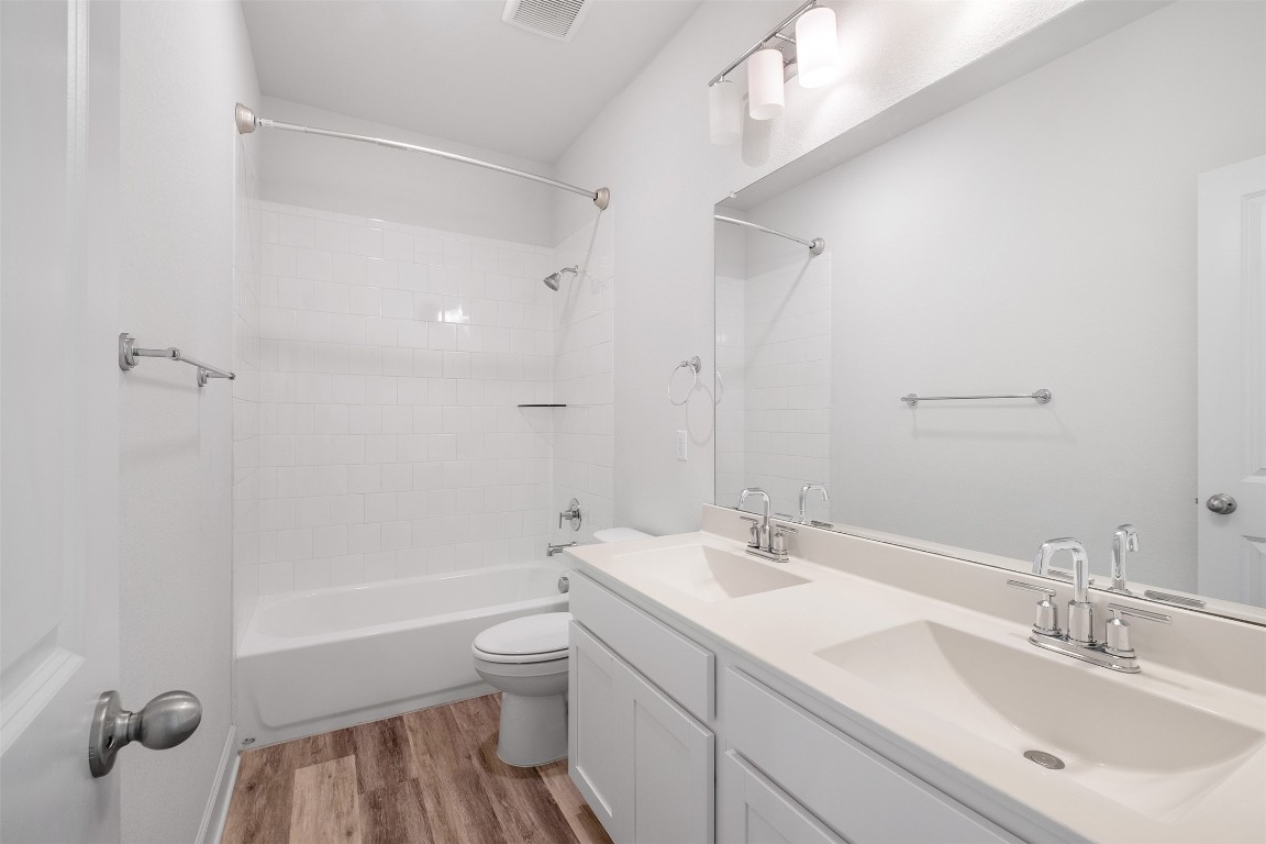 748 Hazy Hills Loop Dripping Springs, TX 78620 - Photo 32 of 40 Full bath with shower combination, double vanity, and light wood-style flooring