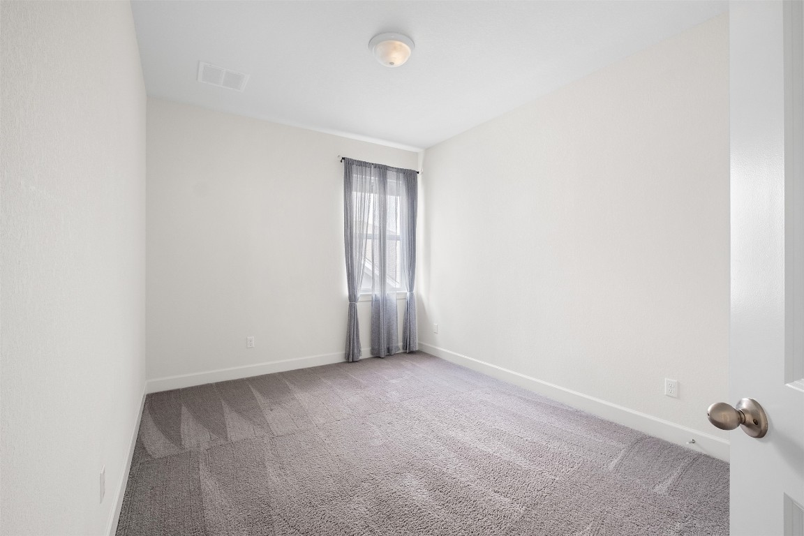 748 Hazy Hills Loop Dripping Springs, TX 78620 - Photo 33 of 40 Unfurnished room with light carpet and baseboards