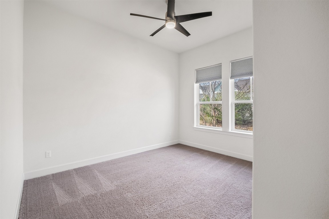 748 Hazy Hills Loop Dripping Springs, TX 78620 - Photo 4 of 40 Spare room featuring light colored carpet and a ceiling fan