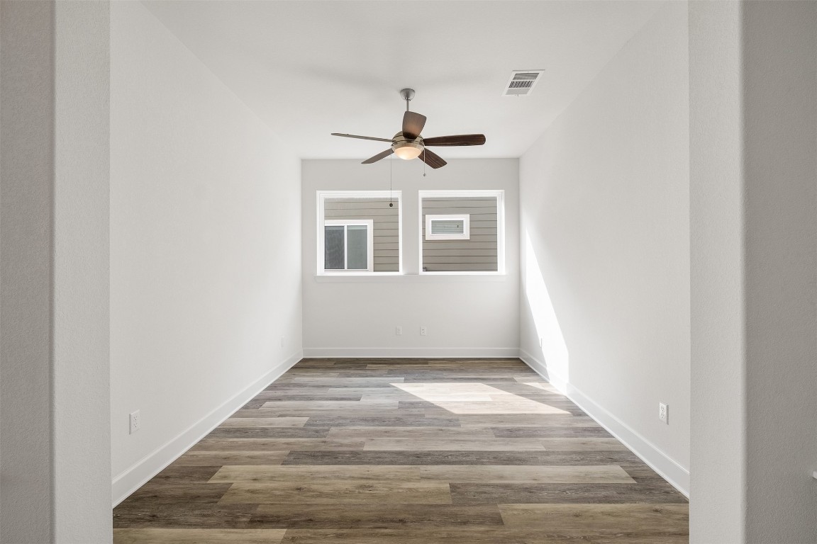 748 Hazy Hills Loop Dripping Springs, TX 78620 - Photo 8 of 40 Spare room with light wood finished floors and a ceiling fan