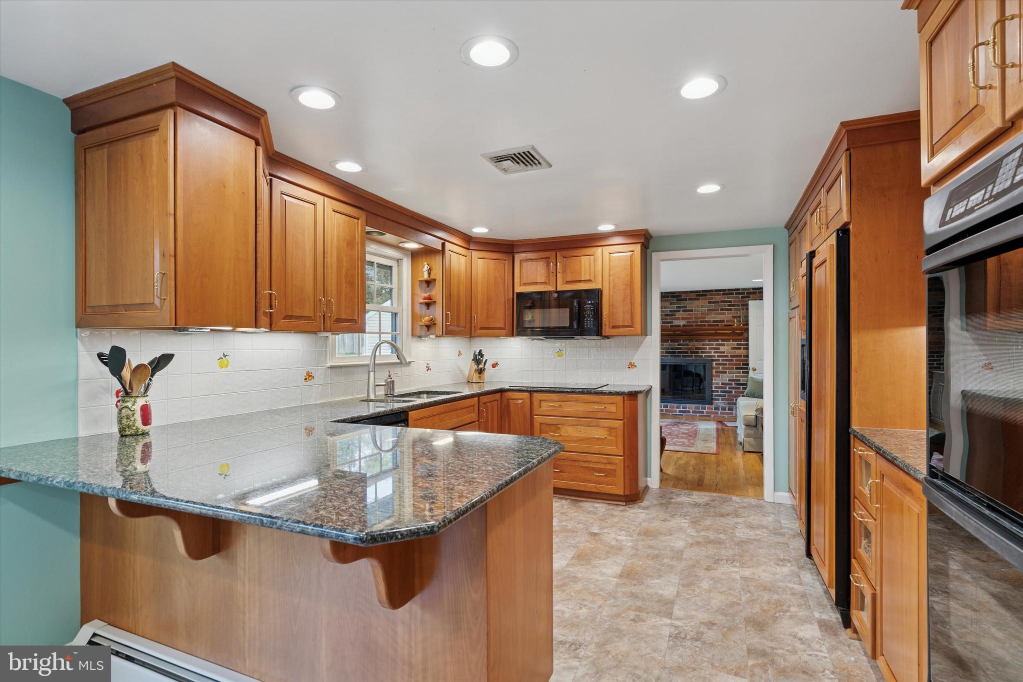 785 Mt Pleasant Road Pottstown, PA 19465 - Photo 12 of 38 a kitchen with stainless steel appliances granite countertop a sink a stove and a refrigerator