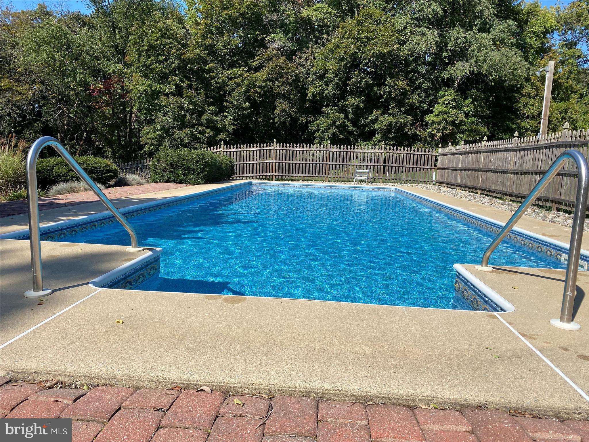785 Mt Pleasant Road Pottstown, PA 19465 - Photo 29 of 38 a view of a swimming pool with a patio and wooden fence