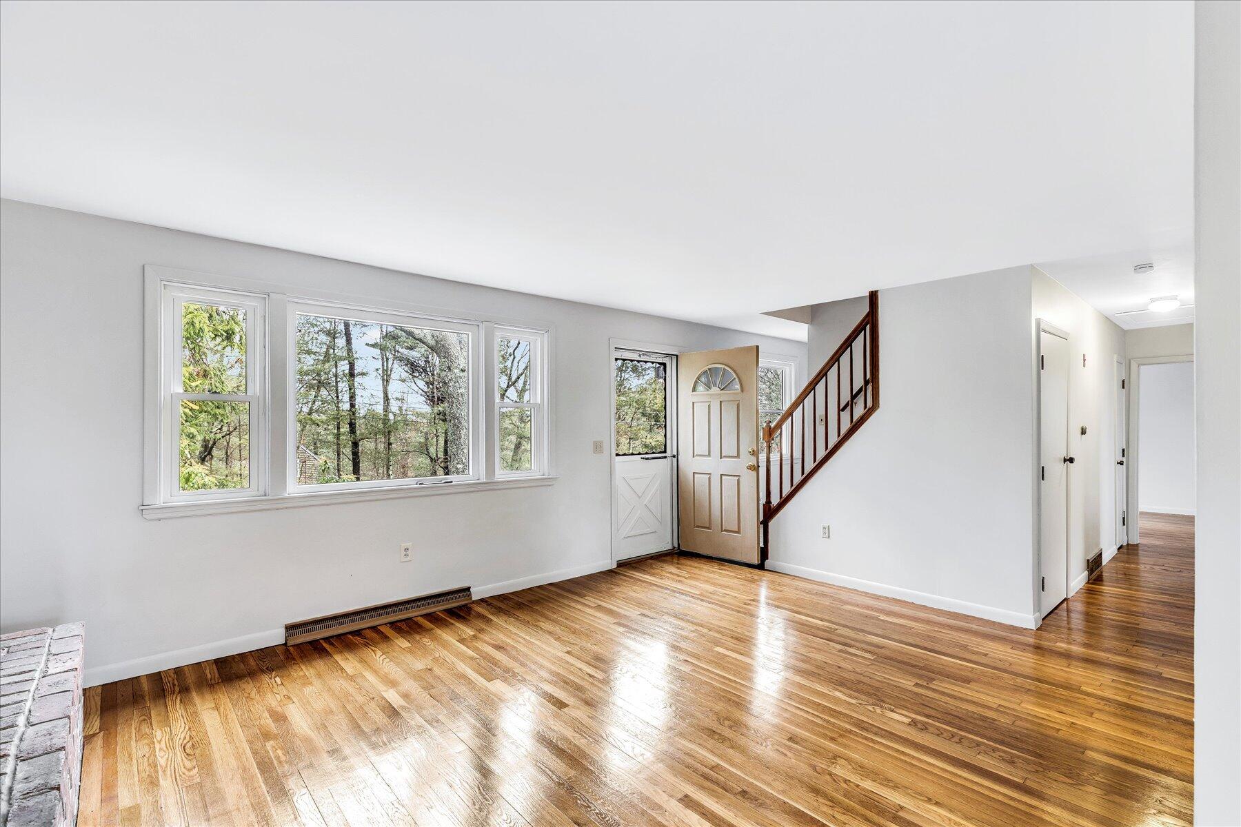 33 Cliff Road Monument Beach, MA 02532 - Photo 3 of 39 a view of an empty room with wooden floor and a window