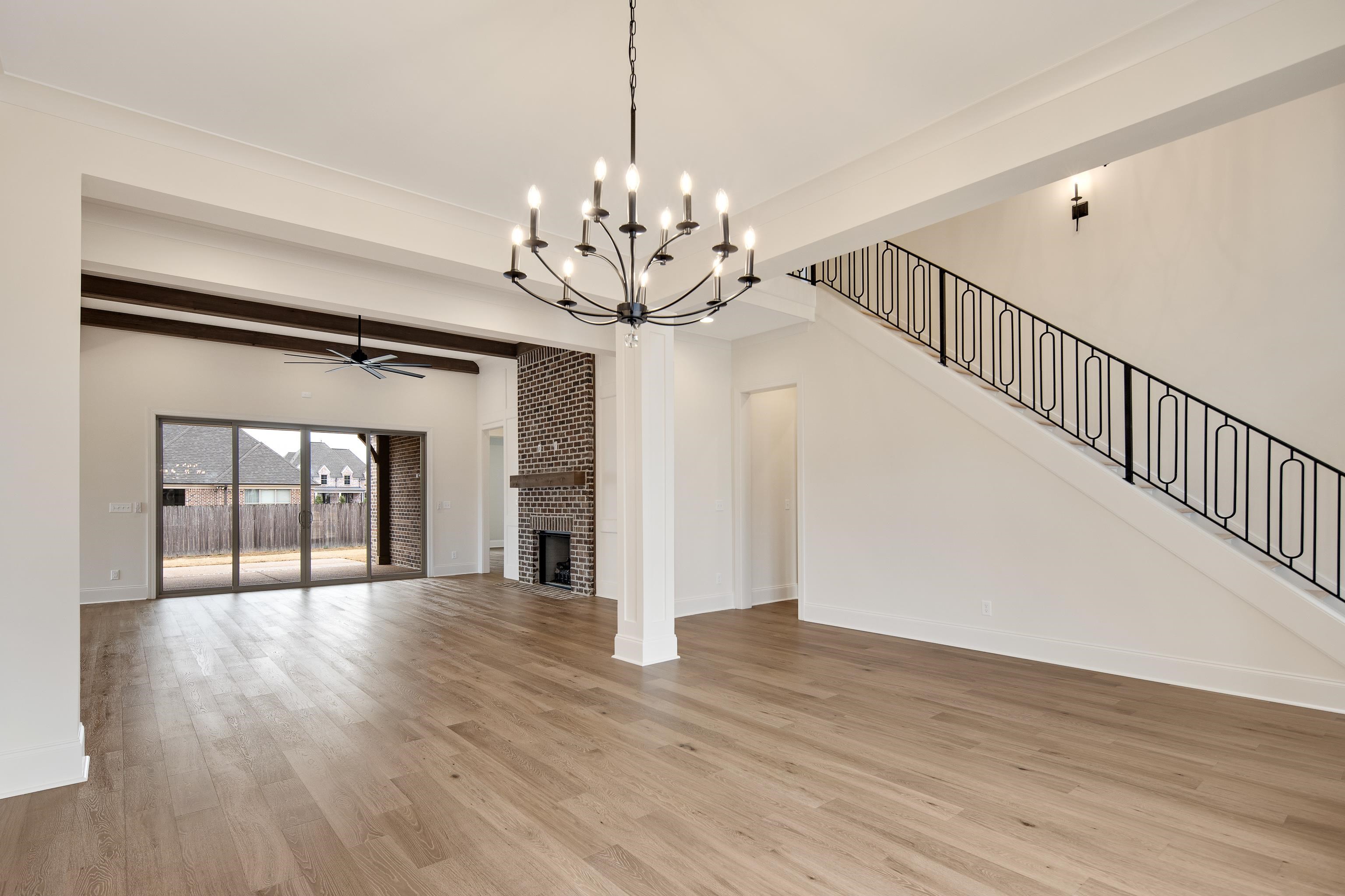 594 Cedar Shadows Circle West Collierville, TN 38017 - Photo 11 of 40 a view of a hallway with wooden floor and chandelier