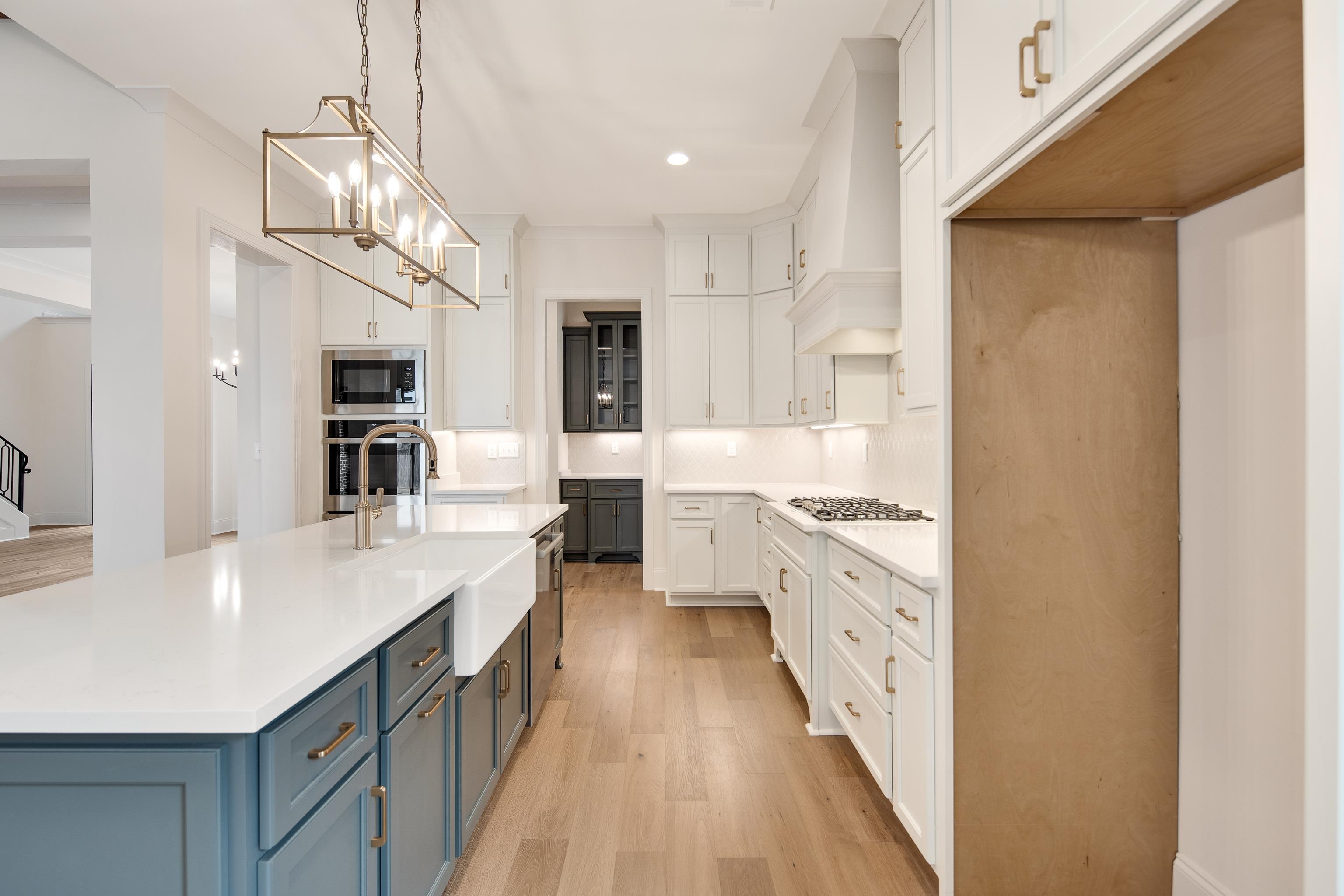 594 Cedar Shadows Circle West Collierville, TN 38017 - Photo 12 of 40 a large kitchen with granite countertop lots of counter space and wooden floor