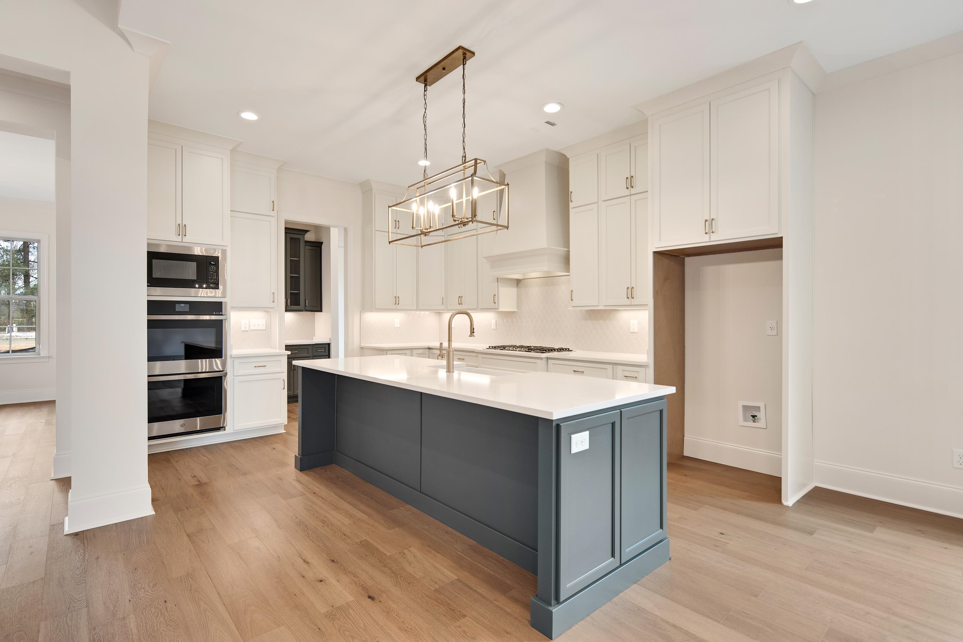 594 Cedar Shadows Circle West Collierville, TN 38017 - Photo 13 of 40 a kitchen with stainless steel appliances granite countertop a sink stove and refrigerator