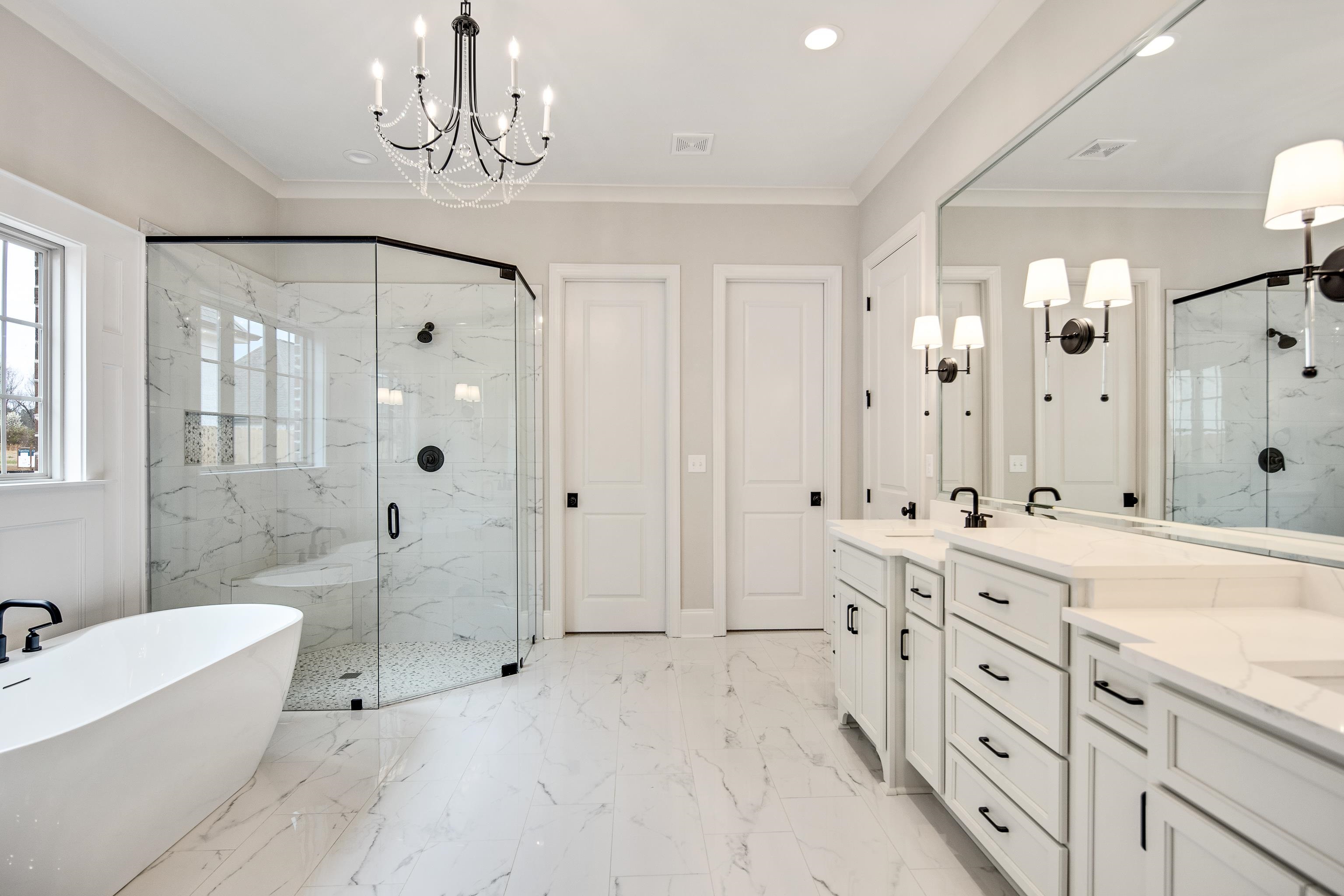 594 Cedar Shadows Circle West Collierville, TN 38017 - Photo 19 of 40 a spacious bathroom with double vanity a sink a mirror a bathtub and shower