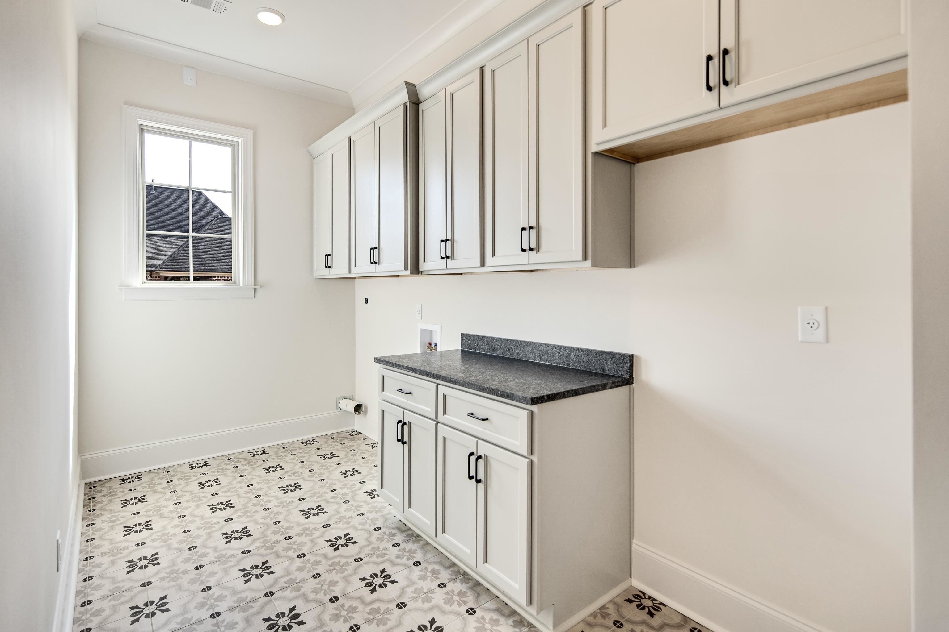 594 Cedar Shadows Circle West Collierville, TN 38017 - Photo 21 of 40 a kitchen with granite countertop a sink and a stove