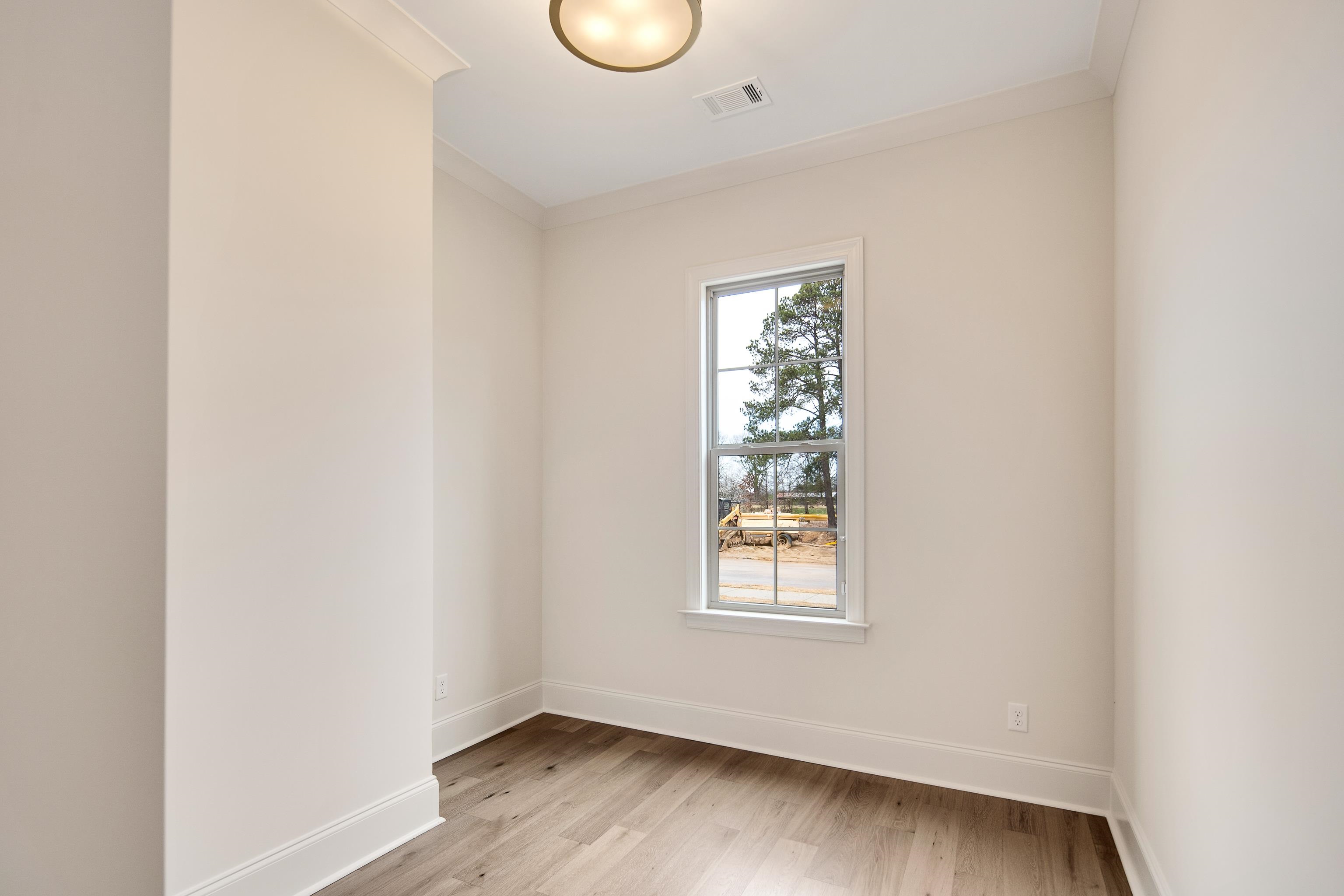 594 Cedar Shadows Circle West Collierville, TN 38017 - Photo 26 of 40 an empty room with wooden floor and windows