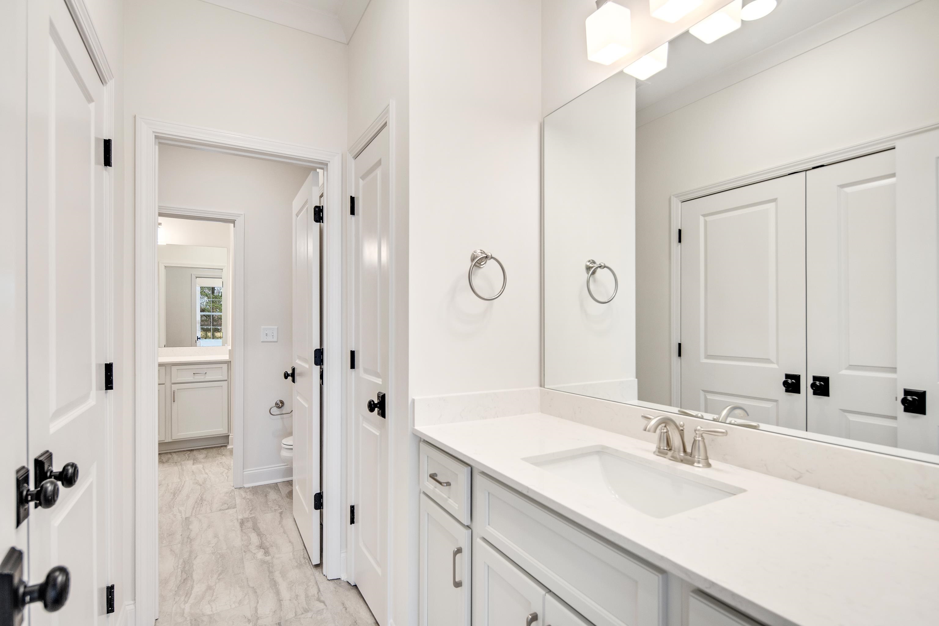 594 Cedar Shadows Circle West Collierville, TN 38017 - Photo 29 of 40 a bathroom with a sink vanity granite tub shower and a mirror