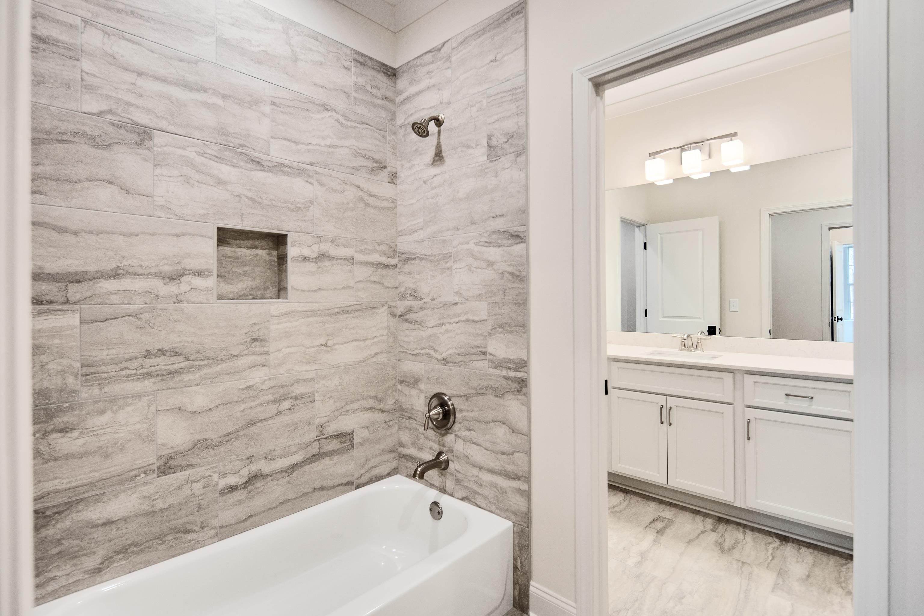 594 Cedar Shadows Circle West Collierville, TN 38017 - Photo 30 of 40 a bathroom with a sink a mirror and a bathtub