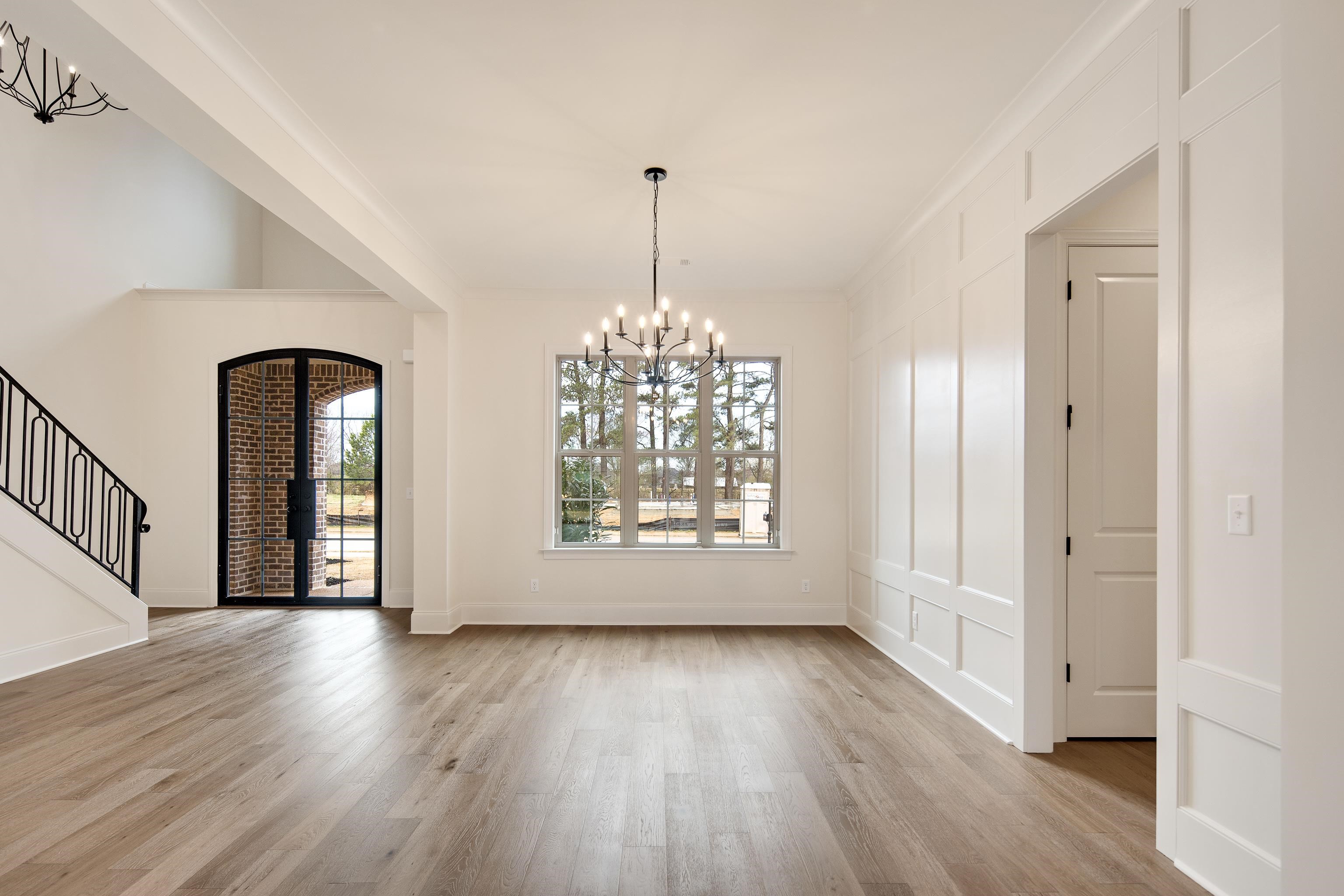 594 Cedar Shadows Circle West Collierville, TN 38017 - Photo 7 of 40 a view of an empty room with wooden floor and a window