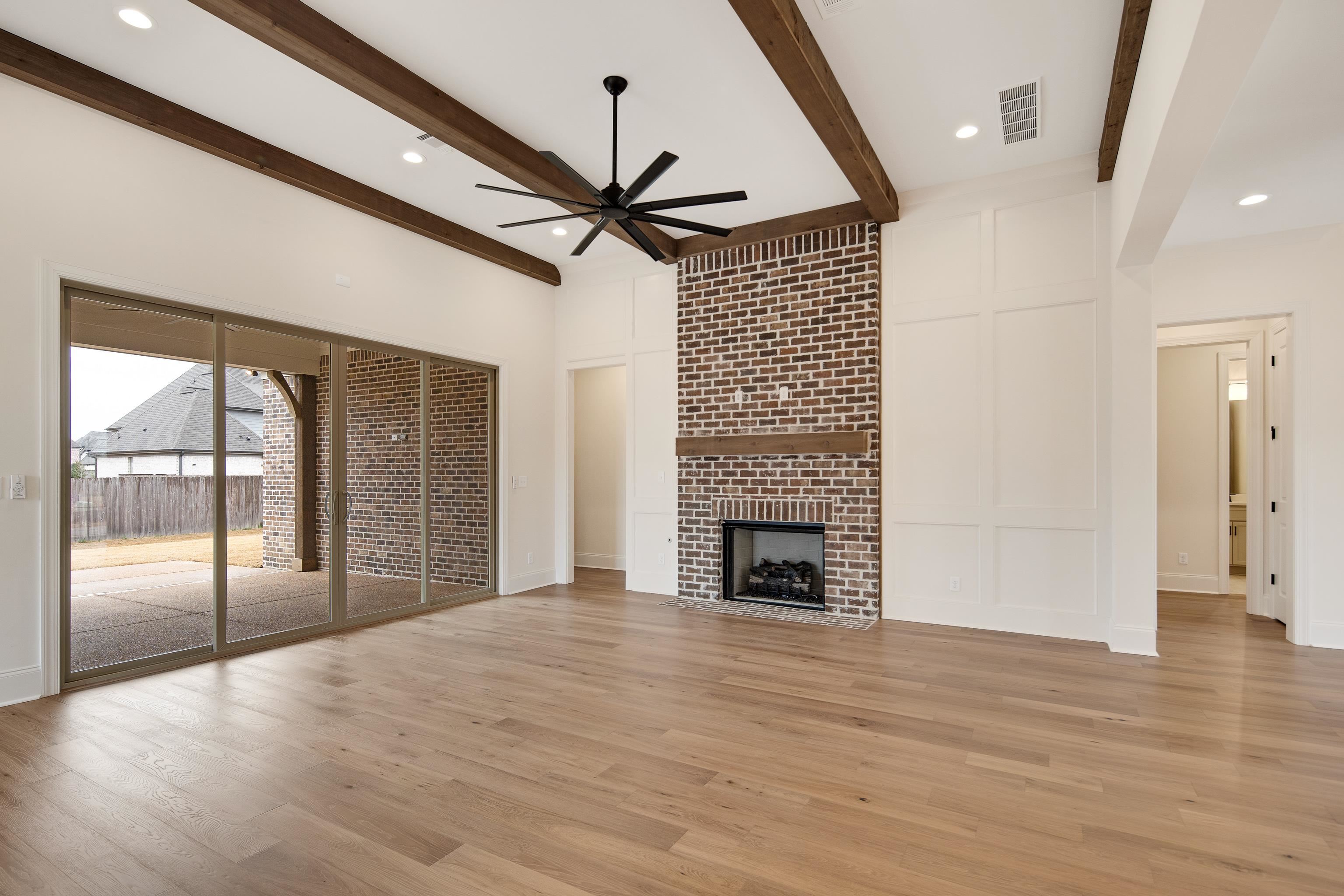 594 Cedar Shadows Circle West Collierville, TN 38017 - Photo 10 of 40 a view of an empty room with wooden floor and a window