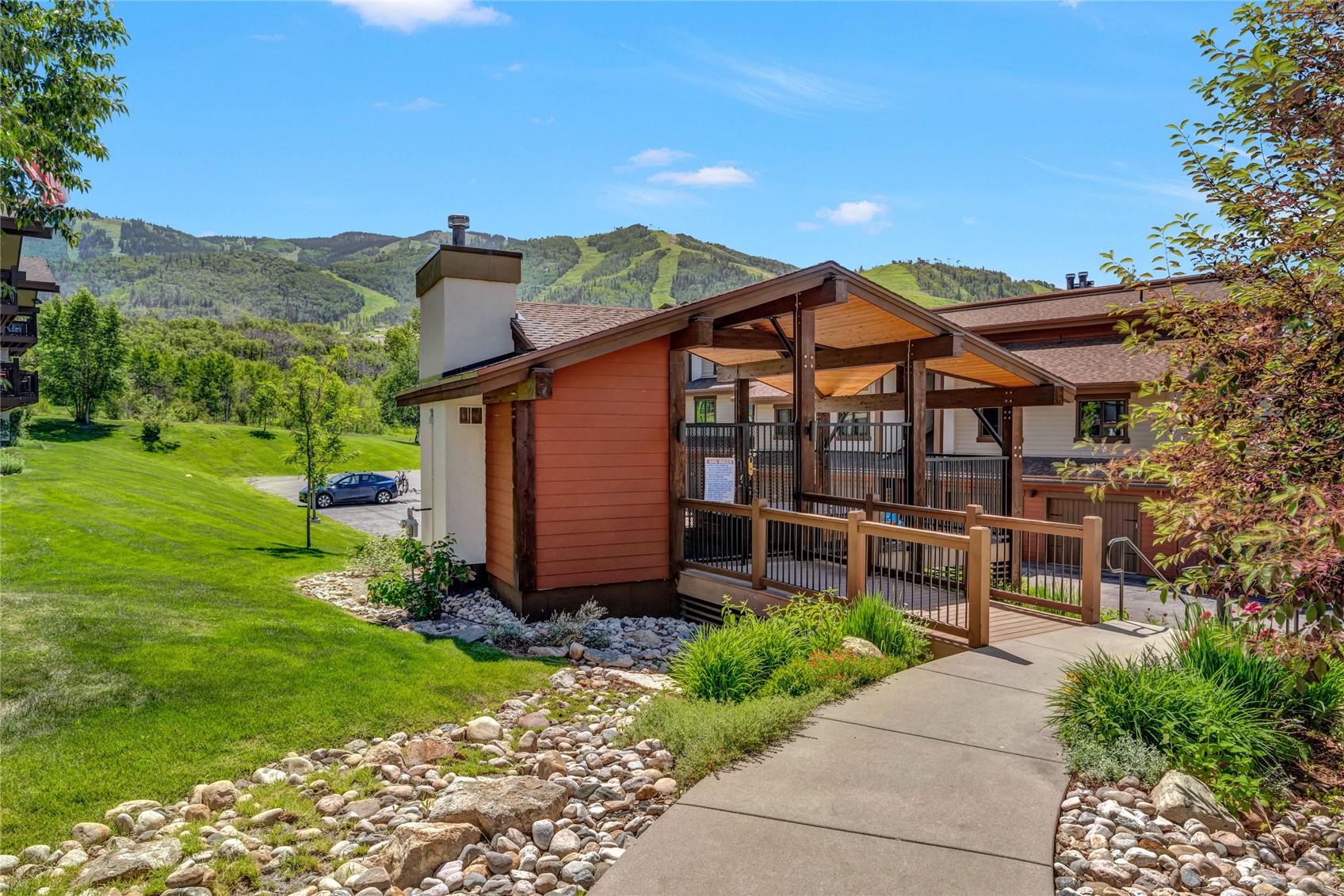 1720 Ranch Road, Unit 309 Steamboat Springs, CO 80487 - Photo 31 of 43 a view of a patio with a table and chairs under an umbrella