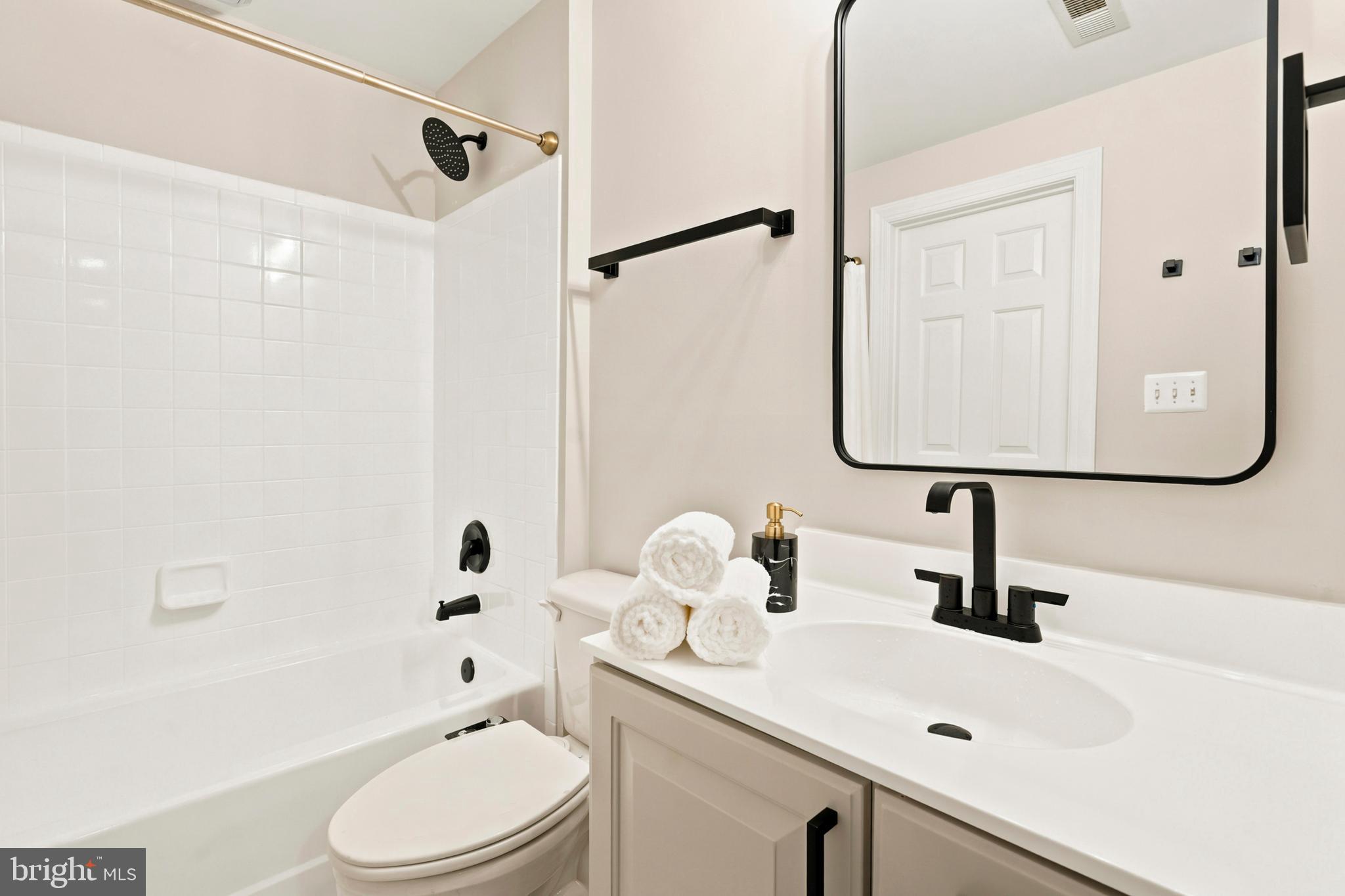 9313 Harrisons Farm Way Laytonsville, MD 20882 - Photo 57 of 77 a bathroom with a sink a toilet and a mirror