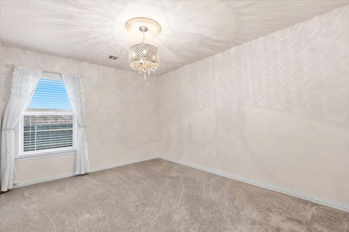 2501 Aspen Meadow Road Leander, TX 78641 - Photo 21 of 30 Spacious room featuring neutral carpeting and textured wall finishes