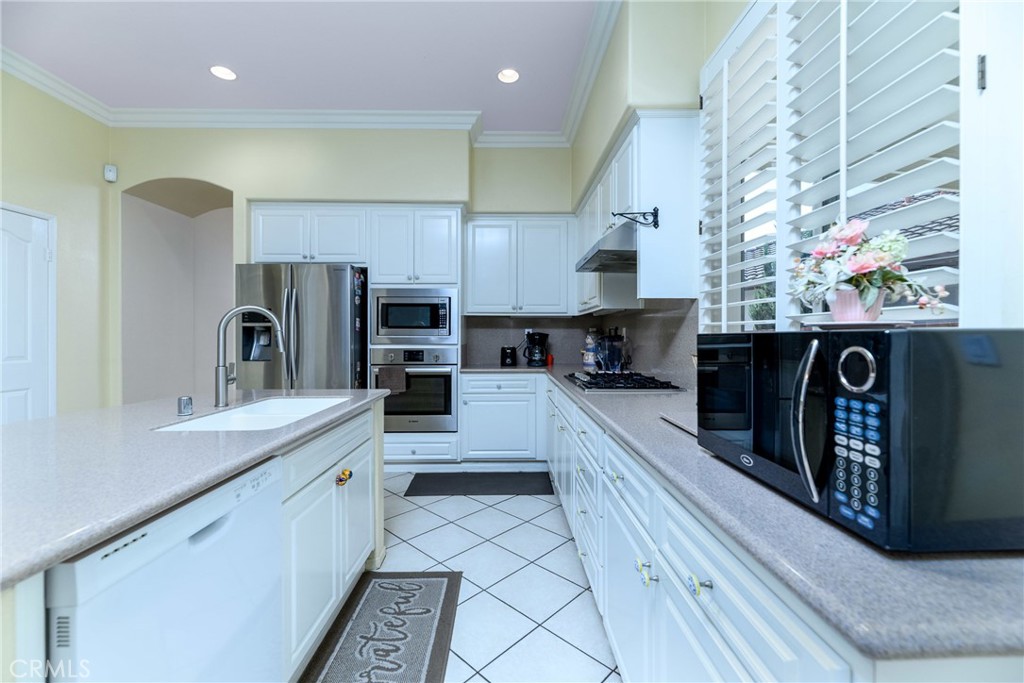 41783 Niblick Road Temecula, CA 92591 - Photo 18 of 33 a large kitchen with stainless steel appliances granite countertop a sink and a refrigerator