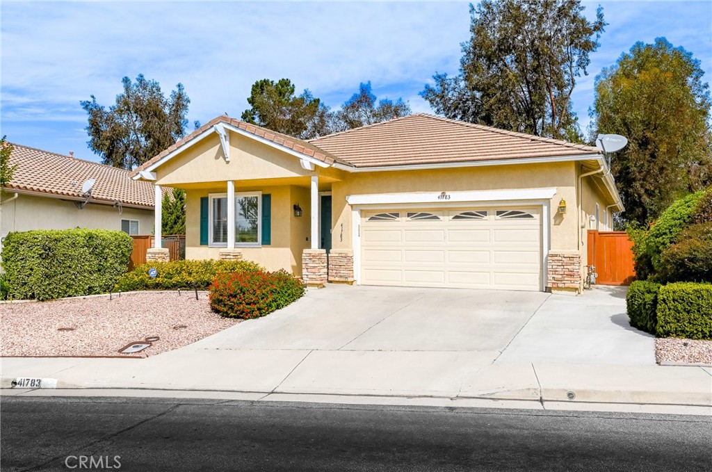 41783 Niblick Road Temecula, CA 92591 - Photo 2 of 33 a front view of a house with a yard and garage