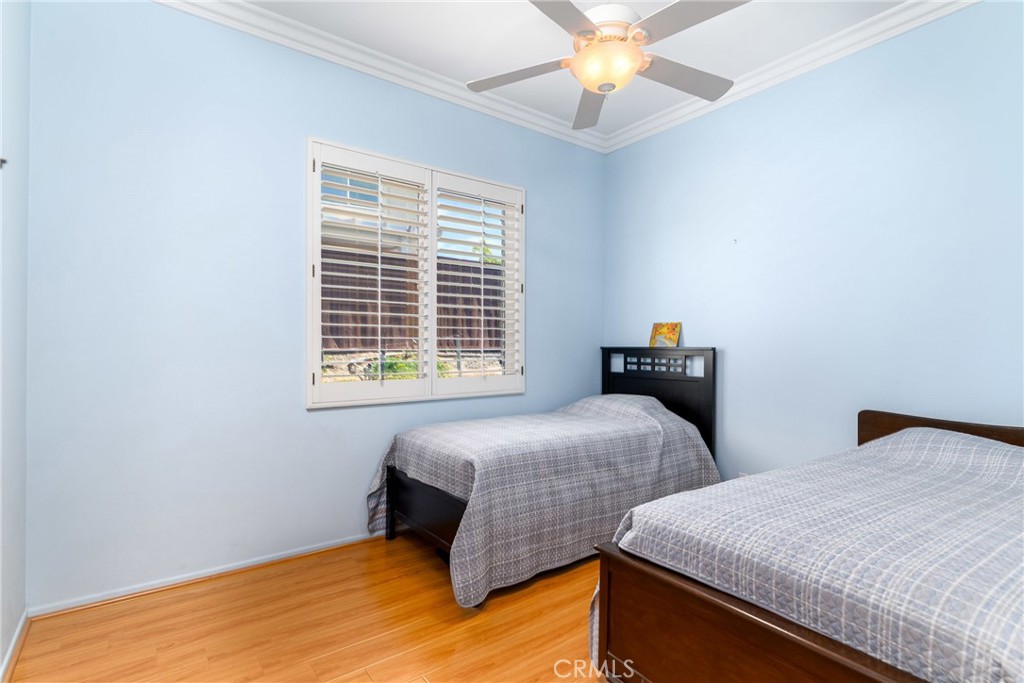 41783 Niblick Road Temecula, CA 92591 - Photo 25 of 33 a bedroom with two beds and a chandelier